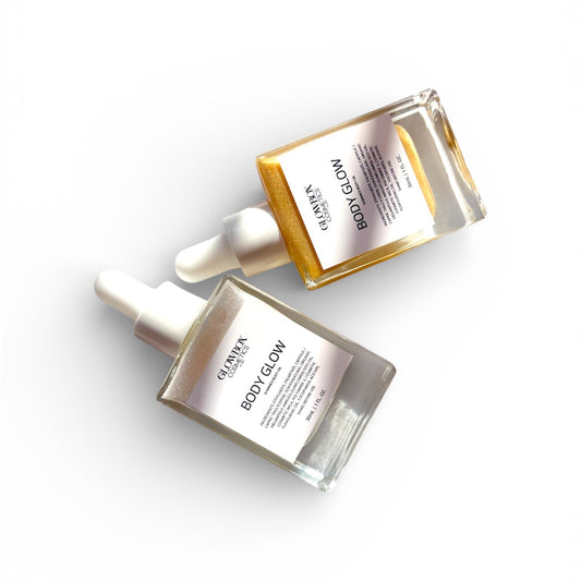 Two skincare bottles labeled 'BODY GLOW' on a white background. Shimmer body oil